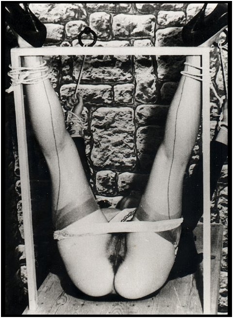 pinup Eve Eden tied to a bondage bench