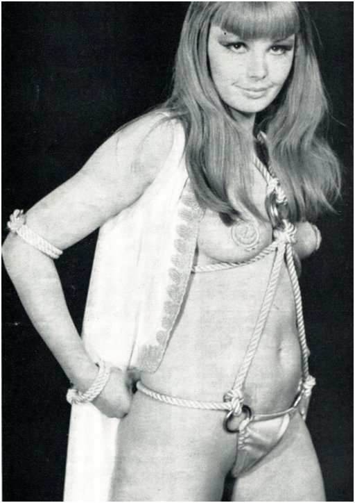 Brigitte Skay wearing a science fiction costume that looks more like a bondage rope harness