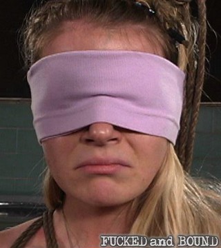 Anita Blue blindfolded and looking sad