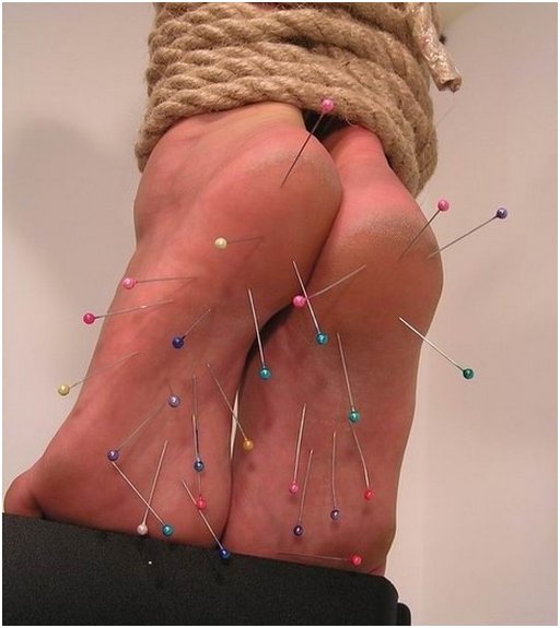 bondage feet with pins poked into them