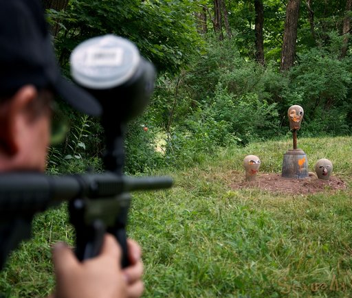 shooting paintballs at a bucket and some creepy mannequin heads