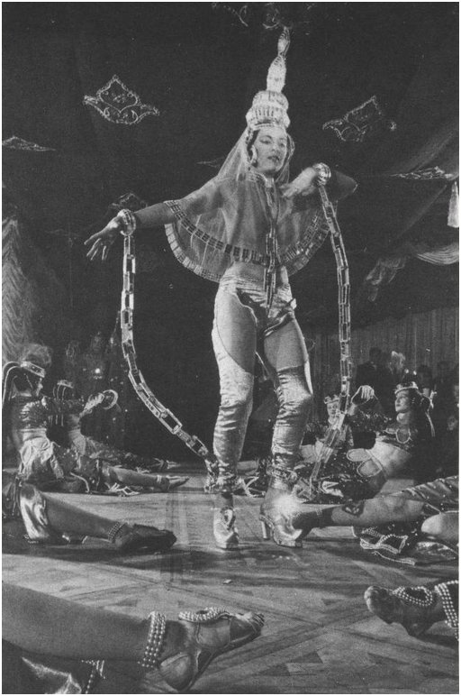 asian woman dancing in dramatic fake chains at an Indian strip club in WWII
