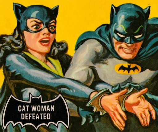 cat woman handcuffed by batman and wearing the bat cuffs