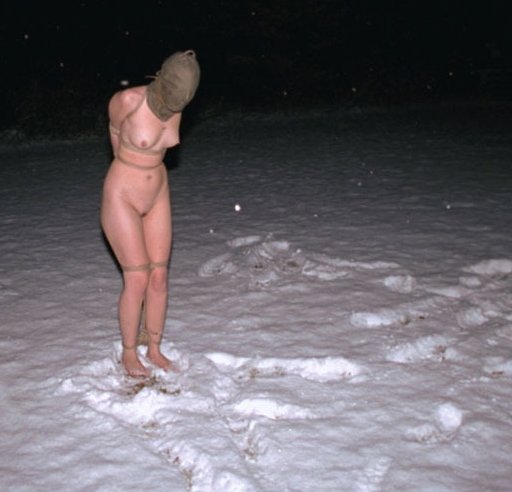 naked slave in the snow wearing nothing but a rope harness and a gunny sack burlap bag hood