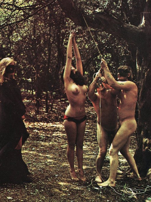creepy cultists tie up a naked woman in the woods