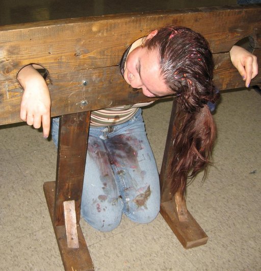 filthy girl in kneeling pillory