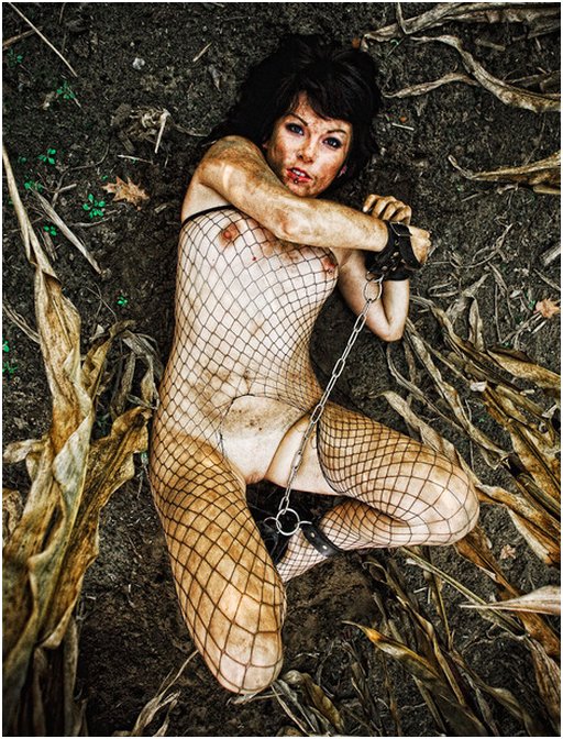 dirty slavegirl in torn fishnets captured in a muddy corn field
