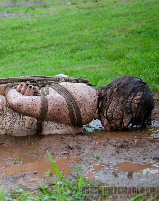 filthy slave girl in a mud puddle