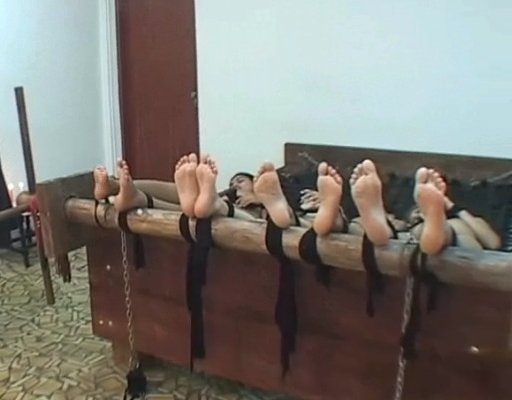 four girls with their feet tied to a punishment bar for falaka/bastinado punishment, or maybe just tickling