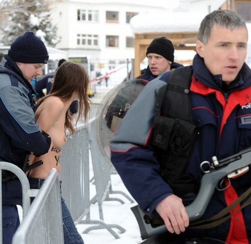 arrested topless woman being hauled away by the cops