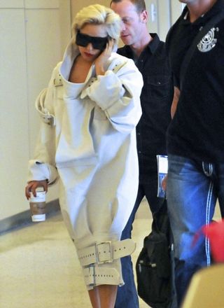 Lady Gaga in a strait-jacket at the airport