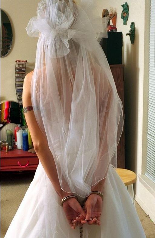bride in handcuffs and veil