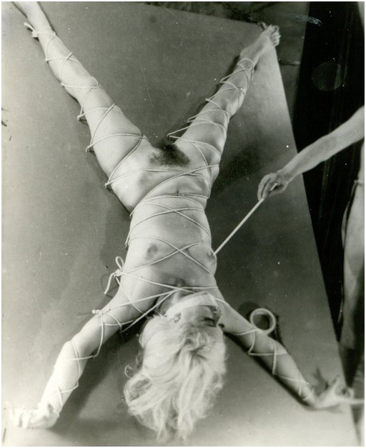 woman tied down and teased with sharp wooden skewer