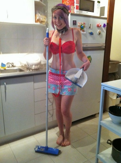 collared leashed housewife about to clean the kitchen