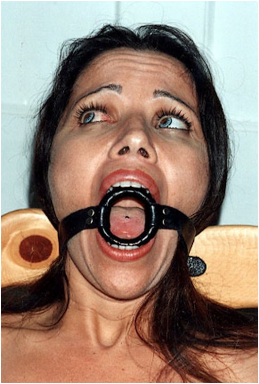 woman with wide eyes over her ring gag
