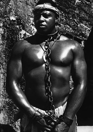 large fit man in iron chains