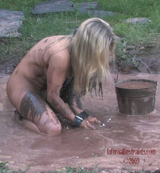 slave girl wallowing in a mud puddle