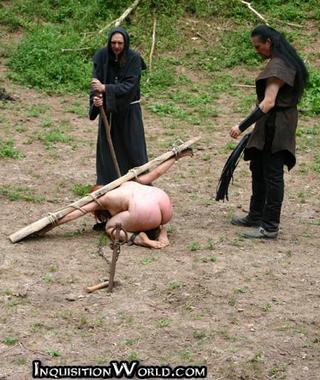 naked witch bound into a wooden yoke and ready for outdoor punishment