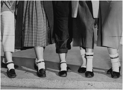 five young women wearing dog collars over white socks on their ankles to signify puppy love