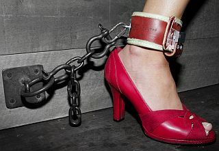 red shoe and a bondage ankle cuff