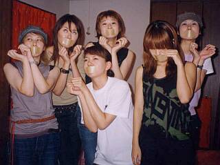 six cute girls wearing tape gags