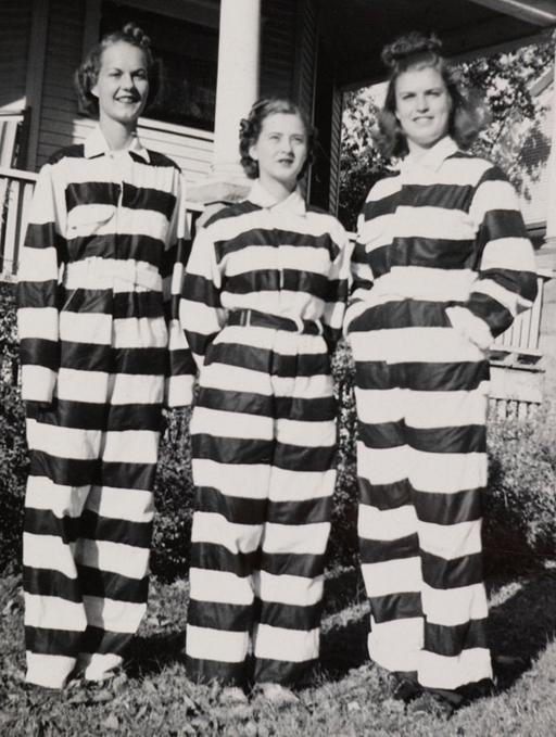 three women in black-and-white striped chain gang convict prisoner outfits