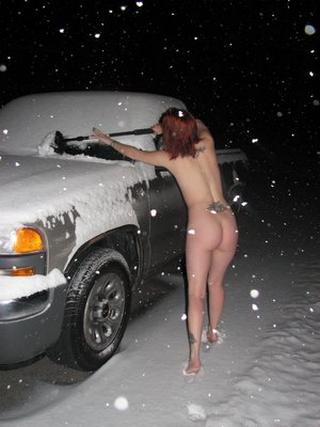 naked woman clearing snow off a truck