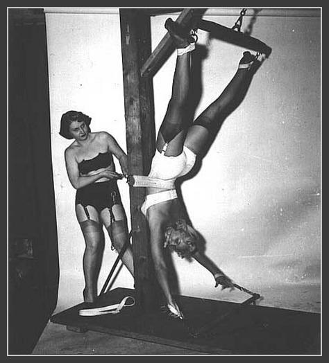 gagged girl suspended upside down in vintage bondage