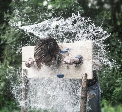 pillory victim takes water balloon to the face