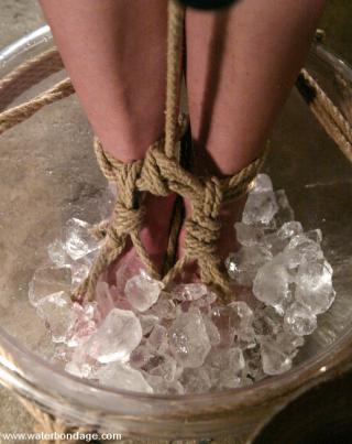 tied with her feet in a bowl of ice