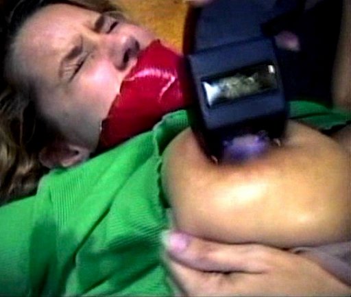 shocking the breast of a gagged girl with a stun gun